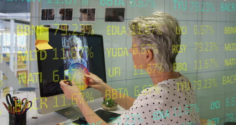 Businesswoman Analyzing Financial Data on Computer in Contemporary Office