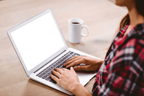 Young woman typing on laptop with transparent screen