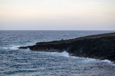Cover background dramatic rocky coastline meeting ocean waves at sunset