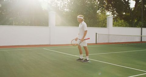Male tennis player on sunny outdoor court