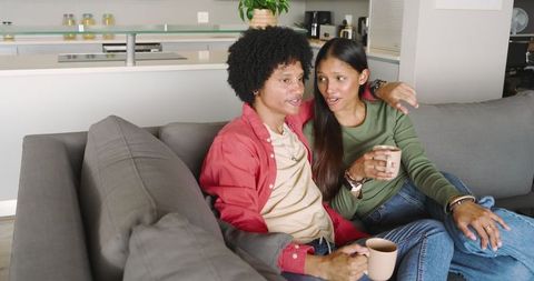 Diverse Couple Relaxing at Home in Modern Kitchen Setting