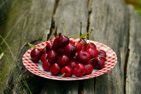 Fresh red cherries on checkered plate outdoors for cherry background