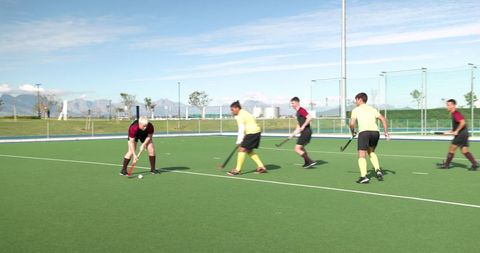 Field Hockey Players Competing Intensely on Bright Green Turf