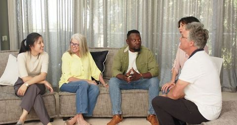 Diverse Therapy Group Sharing Positive Interactions in Comfortable Setting