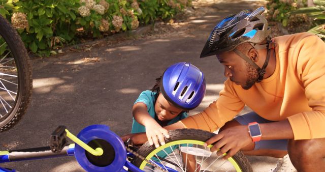 Father and Son Repairing Bicycle Together in the Park - Download Free Stock Images Pikwizard.com