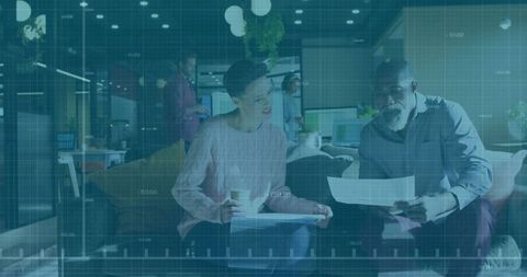 Colleagues discussing documents in contemporary office lounge