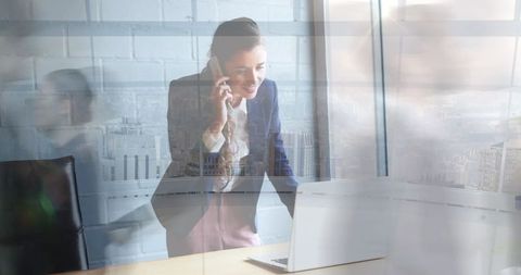 Businesswoman on cellphone with blurred motion in office