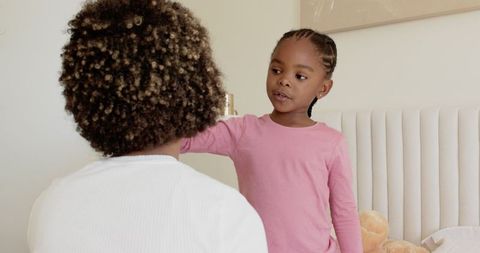 African American Sisters Sharing Tender Moment in Bedroom