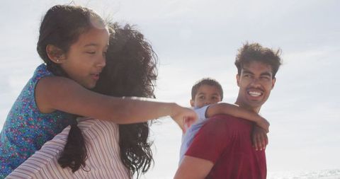 Joyful Family Bonding at Beach on Bright Sunny Day