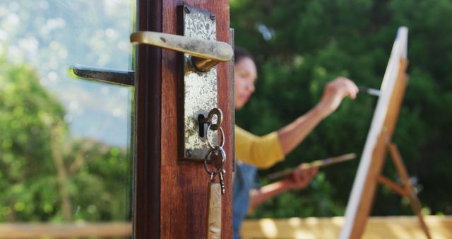 Artist Painting Outdoors Next to Door with Key - Download Free Stock Images Pikwizard.com