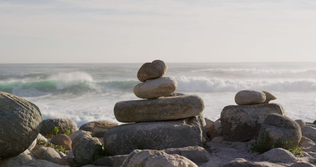 Close up of a rock formations on a beach with ocean and waves in the background on a sunny day in slow motion. Landscape of the coast.