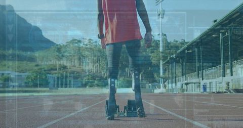 Teen Athlete with Prosthetic Blades Ready on Track