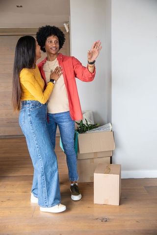 Happy multi-ethnic couple exploring new home together