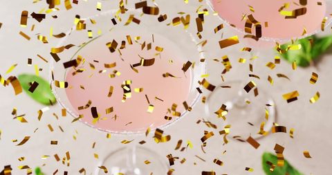 Festive Celebration with Cocktails and Gold Confetti