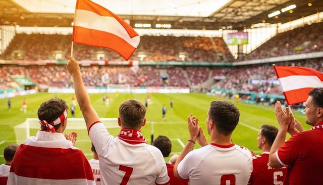 Waving red and white flags cheering fans in stadium stands supporting football team
