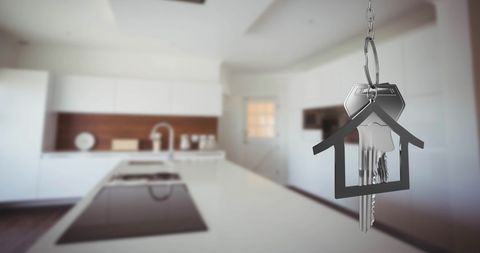 House Keys with Symbolic Home Fob Hanging in Modern Kitchen