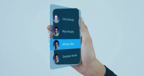 Holding transparent smartphone showing contact list with highlighted contact and avatars
