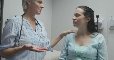 Doctor Reassuring Pregnant Patient During Prenatal Consultation, Compassionate Care