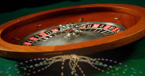 Spinning wooden roulette wheel on casino table