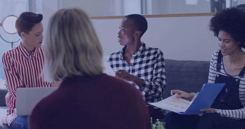 Diverse Professional Team Engages in Modern Office Discussion