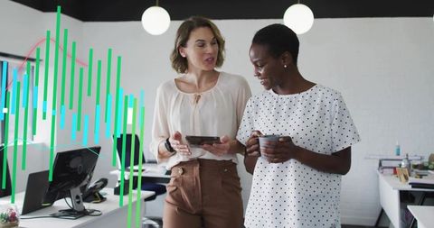Mid-adult coworkers discussing data on tablet in modern open-plan office with visualization overlay