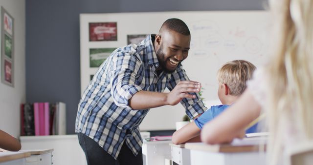 Happy Teacher Interacting with Students in Classroom - Download Free Stock Images Pikwizard.com