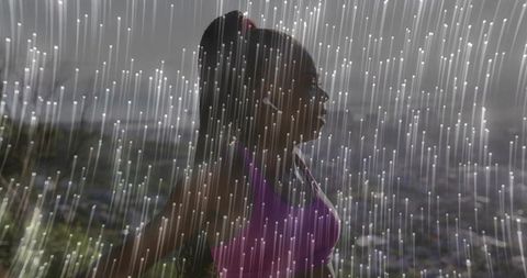 Determined runner posed on rainy hillside