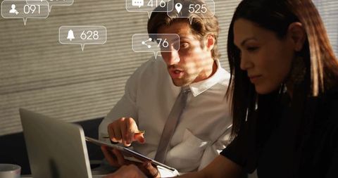 Professional business discussion with modern technology in office