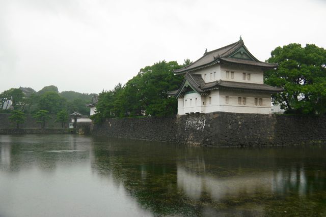 Historic Japanese Castle Reflecting in Tranquil Moat on Cloudy Day - Download Free Stock Images Pikwizard.com
