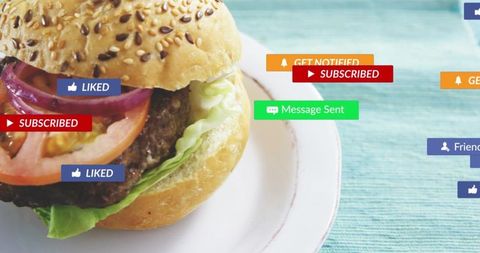 Gourmet burger resting on sesame bun with social media badges and teal copy space