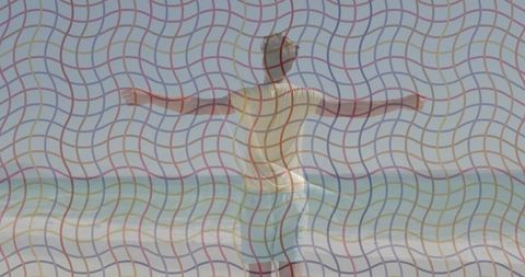 Serene man in swim shorts embracing ocean breeze at sunset beach