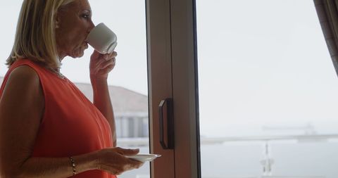 Senior Woman Enjoys Peaceful Coffee Moment by Window