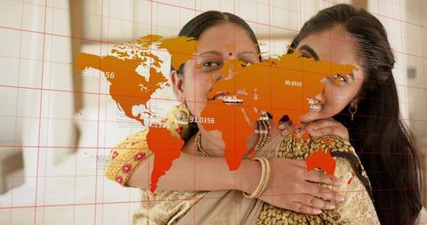 Indian mother and daughter embracing in patterned saris with world map overlay