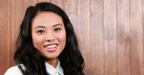 Smiling Biracial Woman Portrait on Wooden Background