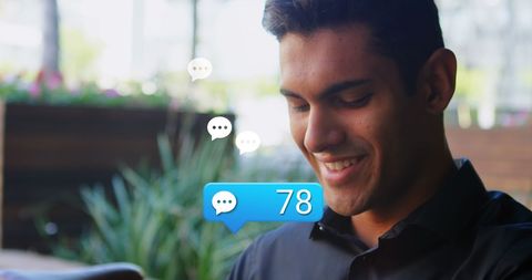 Man Engaging with Social Media on Smartwatch Outdoors