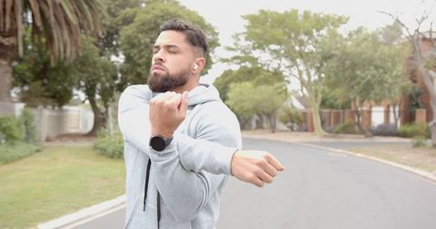 Athletic Man Stretching on Suburban Road Ready for Workout