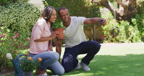 Joyful Couple Taking Selfie While Gardening on Sunny Day