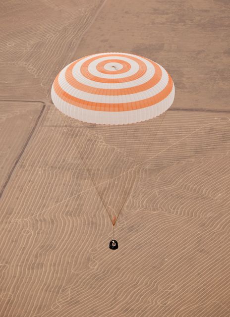 Parachute fully deployed with Russian cosmonauts Alexander Skvortsov and Mikhail Kornienko, and NASA astronaut Tracy Caldwell Dyson during return from a six-month mission on the International Space Station. Useful for articles on space missions, astronaut recovery operations, or the Soyuz spacecraft missions.