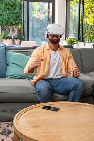 Man engaging with virtual reality headset in comfortable living room