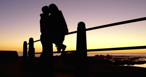 Silhouette of Young Couple Embracing at Sunset Over Ocean - Download Free Stock Images Pikwizard.com
