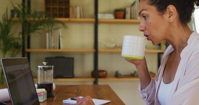 Focused Woman Working Remotely in Home Office with Laptop and Coffee - Download Free Stock Images Pikwizard.com