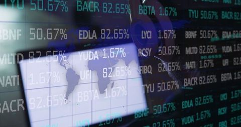 Man Navigating Map with Stock Ticker Display at Workstation