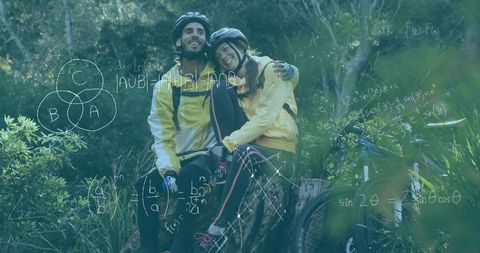 Couple Wearing Yellow Jackets Resting on Stump After Mountain Bike Ride with Math Diagrams
