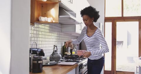 Woman Cooking Pancakes in Bright Kitchen - Download Free Stock Images Pikwizard.com