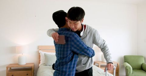 Father and son bonding while preparing for trip with luggage