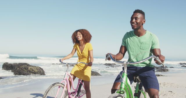 Happy Couple Riding Bicycles on Beach on a Sunny Day - Download Free Stock Images Pikwizard.com