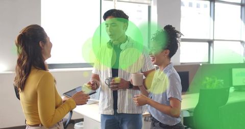 Young professionals collaborating in modern office with green overlay bubbles and coffee