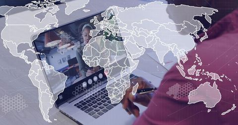 Woman taking notes during remote video meeting with global network overlay and laptop