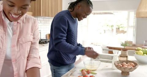 African American Couple Cooking Together in Cozy Home Kitchen