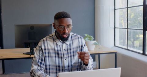 Focused Professional Man Working on Laptop in Modern Office - Download Free Stock Images Pikwizard.com